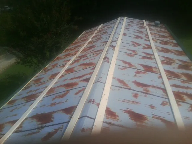 Rusted metal roof panels with new wood purlins before replacement — Storm Damage Roof Repair in Seffner by Roofing Brothers